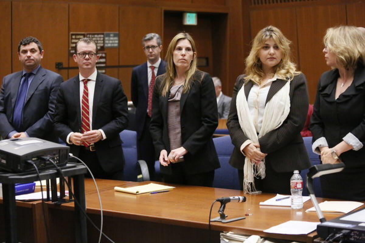 Yevgeny "Eugene" Selivanov, far left, and Tatyana Berkovich, second from right, were found guilty Friday of several charges related to a case involving the taking or misappropriating of more than $200,000 in public funds.