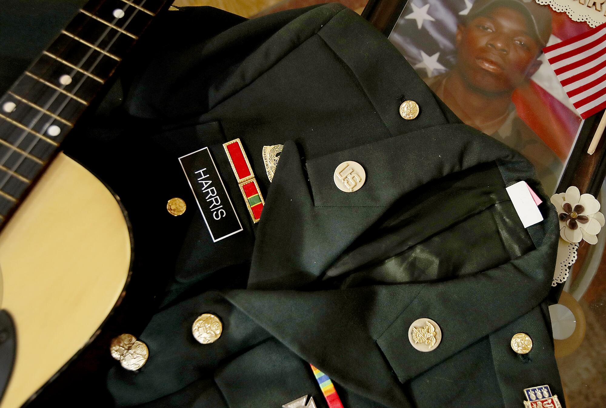 Leroy Harris III's dress uniform jacket, guitar and pictures from his days in the military