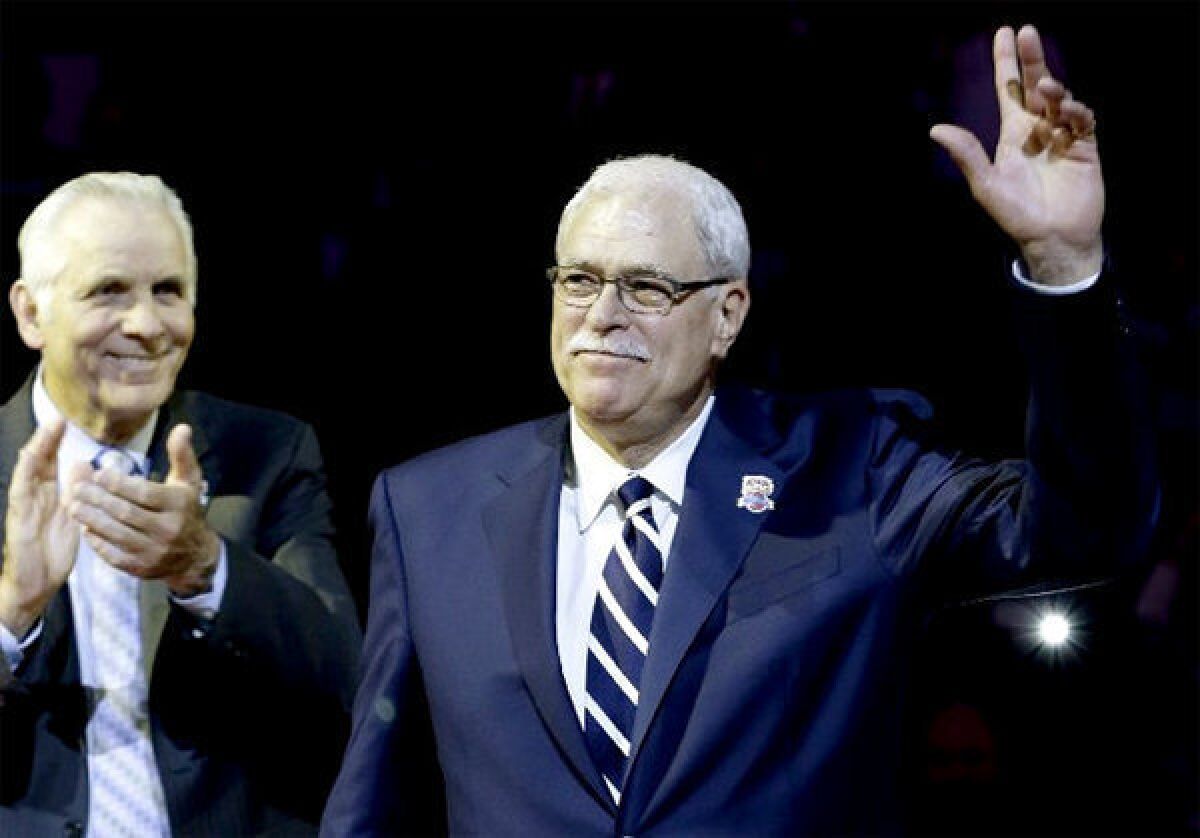 Phil Jackson waves to the crowd during a halftime ceremony to honor the 1972-73 New York Knicks.
