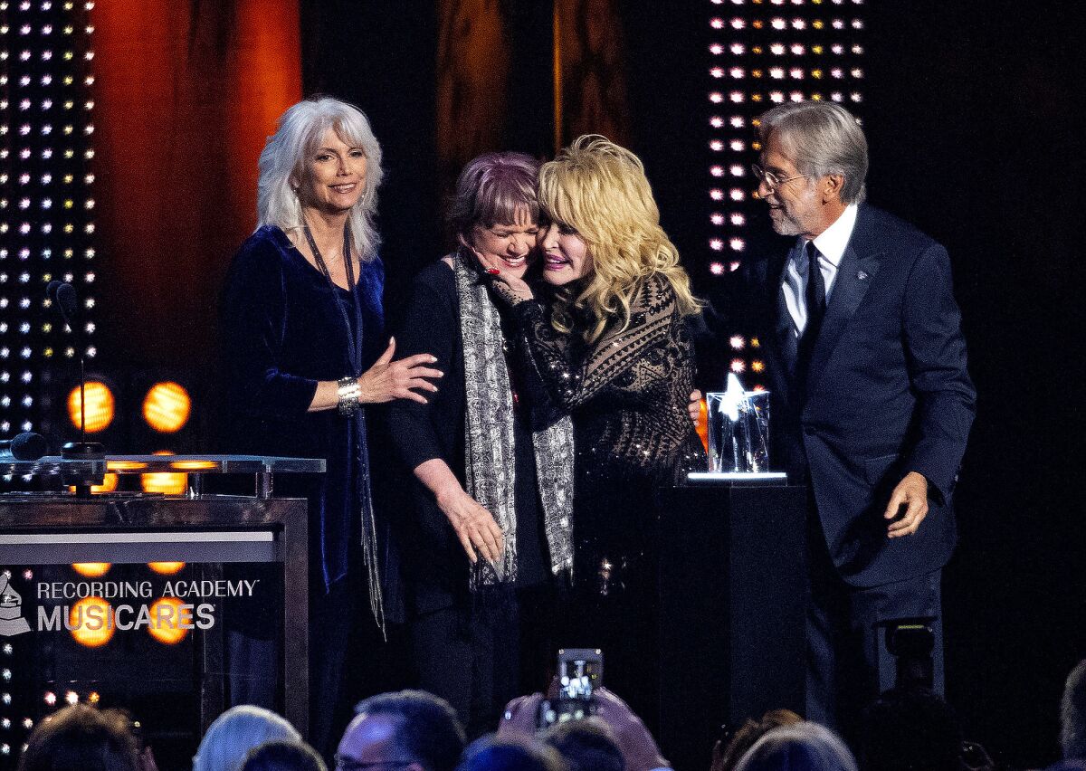 Emmylou Harris, left, Ronstadt, Dolly Parton and Neil Portnow, chief executive of the Recording Academy, at an event this year.