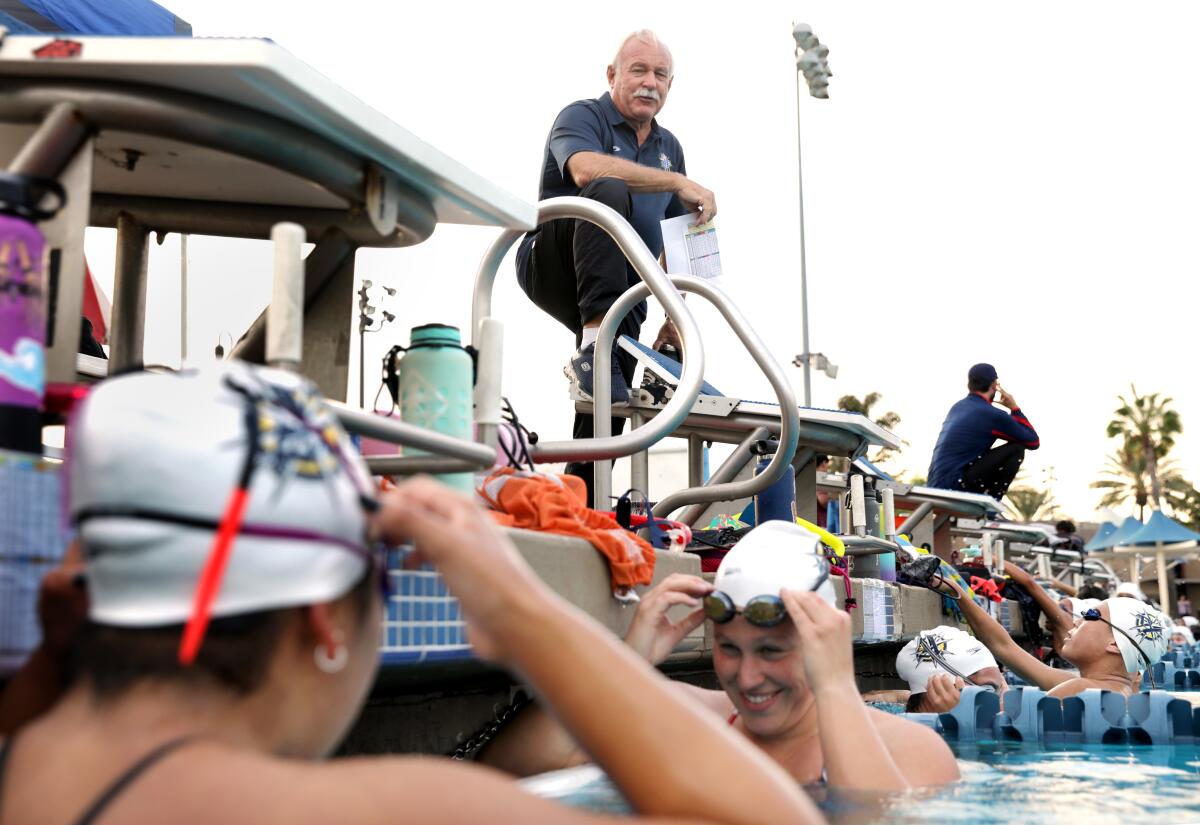 Coach Rick Shipherd, top, leads a workout with swimmers of La Mirada Armada