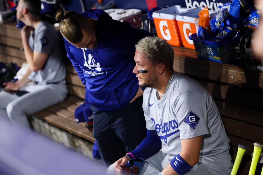 SAN DIEGO, CALIFORNIA - OCTOBER 08: Miguel Rojas #11 of the Los Angeles Dodgers sits.