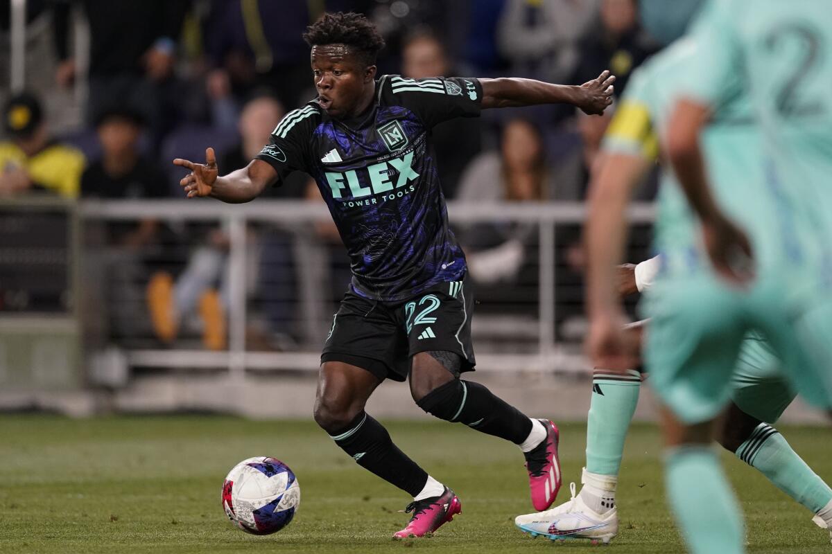 LAFC forward Kwadwo Opoku tries to get past Nashville SC defenders.