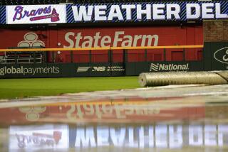 The rain cover is seen at Truist Park after a baseball game was postponed between the Atlanta Braves and the San Diego Padres do to rain, Saturday, May 18, 2024, in Atlanta. (AP Photo/Mike Stewart)