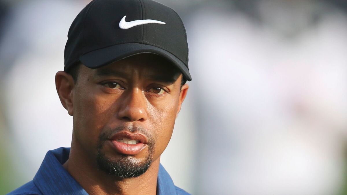 Tiger Woods reacts on the 10th hole during the first round of the Dubai Desert Classic golf tournament on Feb. 2.