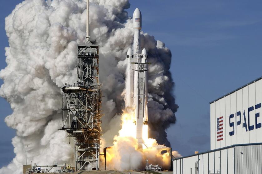 A Falcon 9 SpaceX heavy rocket lifts off from pad 39A at the Kennedy Space Center in Cape Canaveral, Fla., Tuesday, Feb. 6, 2018. The Falcon Heavy, has three first-stage boosters, strapped together with 27 engines in all. (AP Photo/John Raoux)