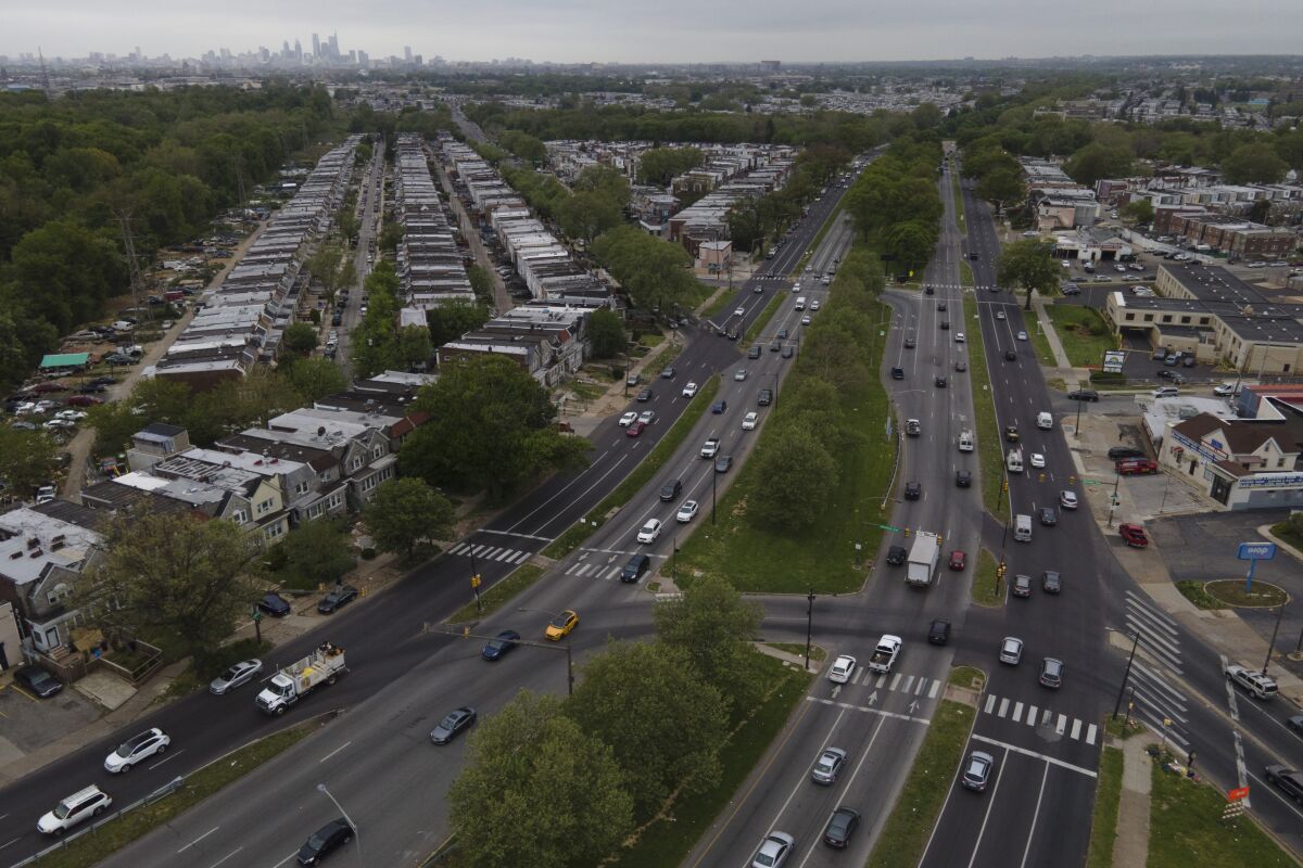 The Philadelphia skyline is seen at a distance as vehicular traffic flows along Roosevelt Boulevard. 