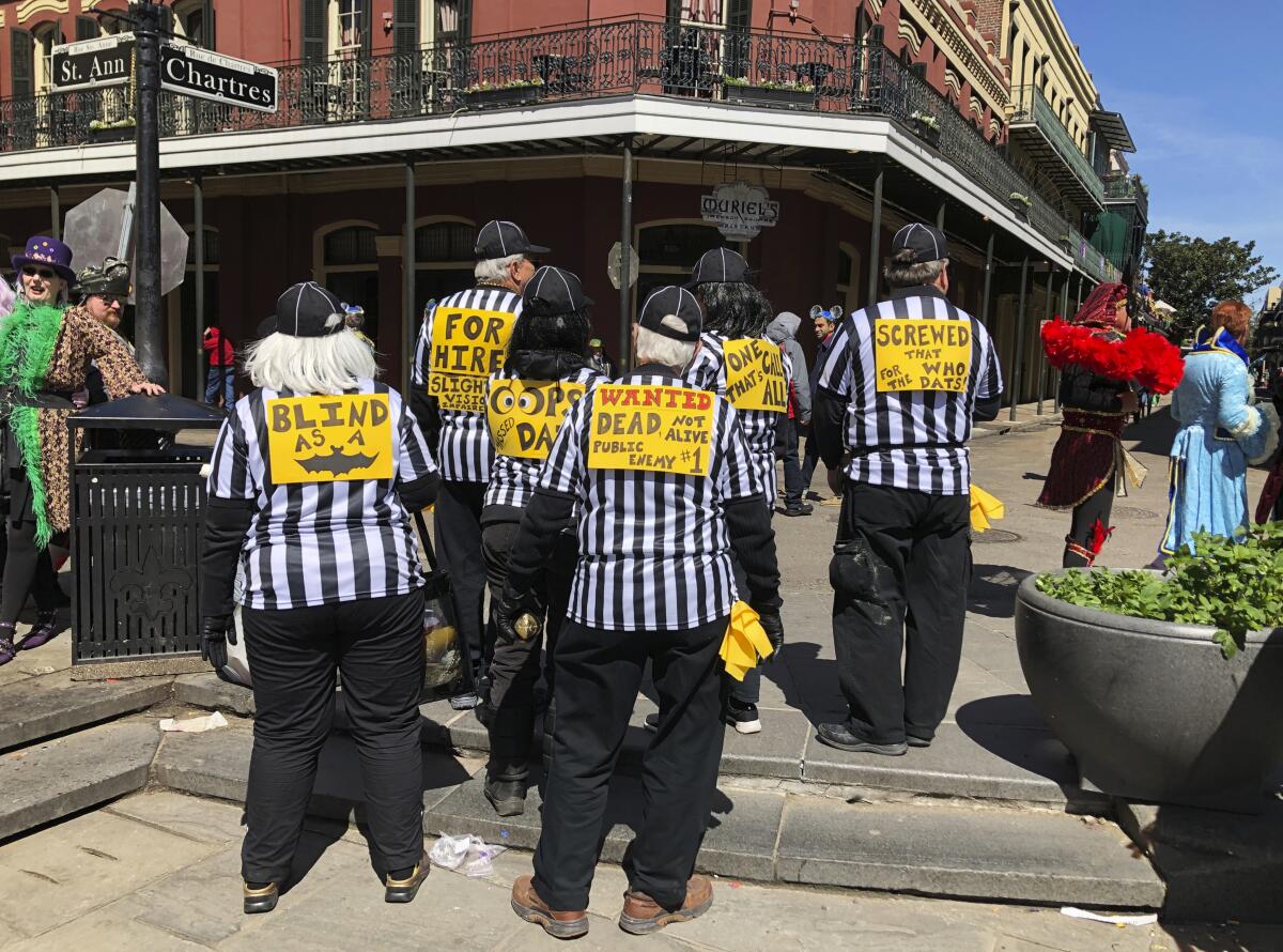 A group of people dressed as blind referees attend Fat Tuesday celebrations in New Orleans in March.