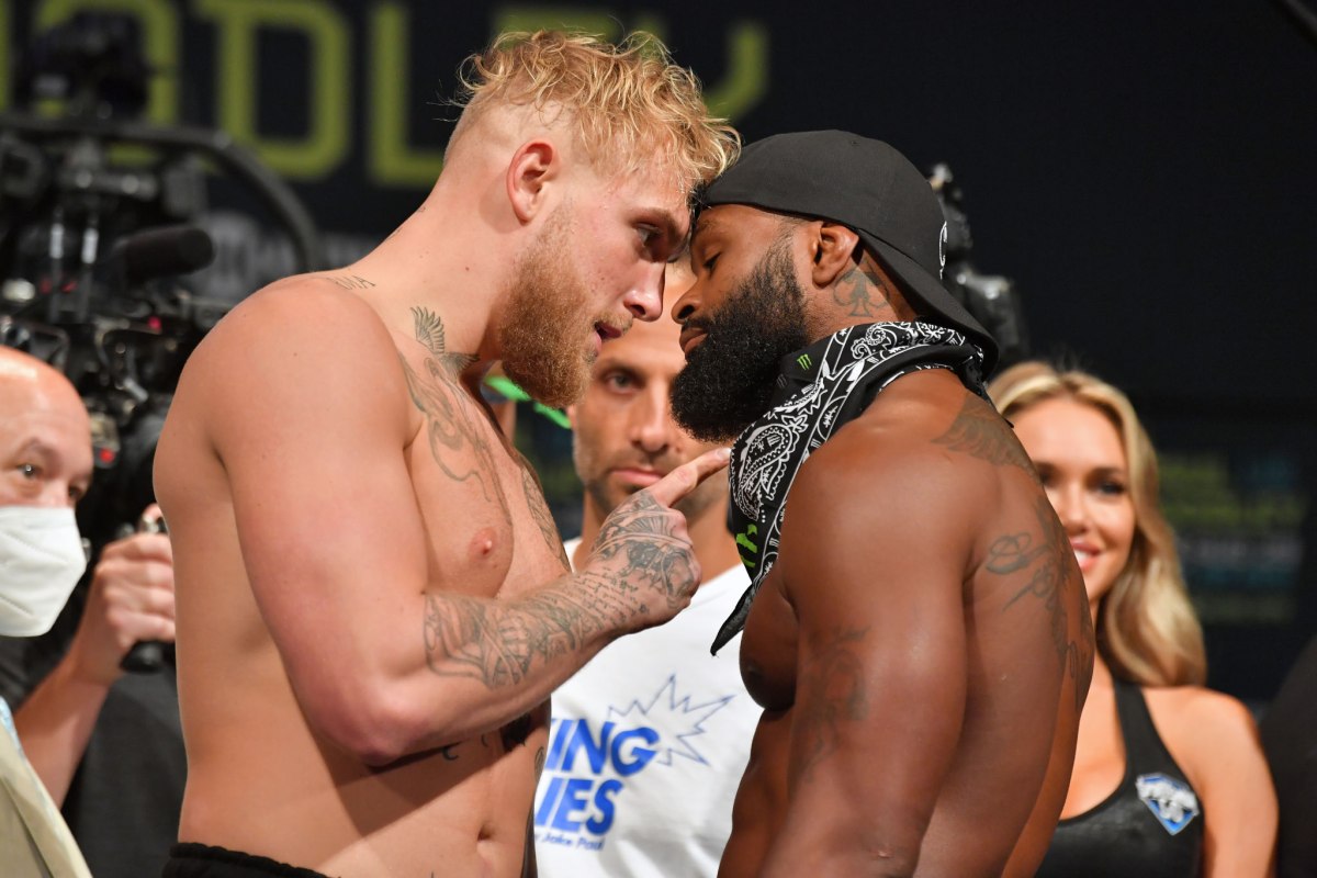 Jake Paul and Tyron Woodley face off during their weigh-in on Saturday.