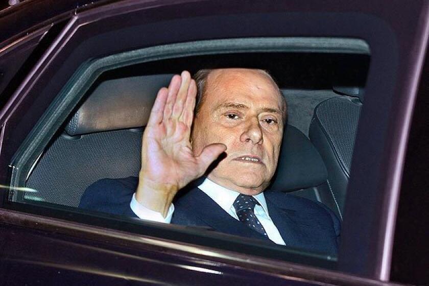 Italian Prime Minister Silvio Berlusconi leaves the Quirinale, the presidential palace, after meeting with Italian President Giorgio Napolitano, in Rome, Saturday. Berlusconi resigned after Parliament's lower chamber passed reforms demanded by the European Union.