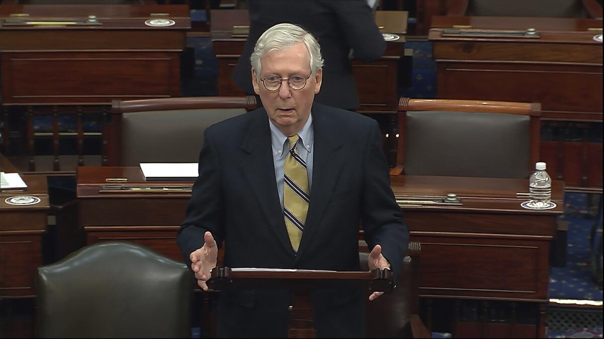 Senate Minority Leader Mitch McConnell speaks at a lectern on the Senate floor.
