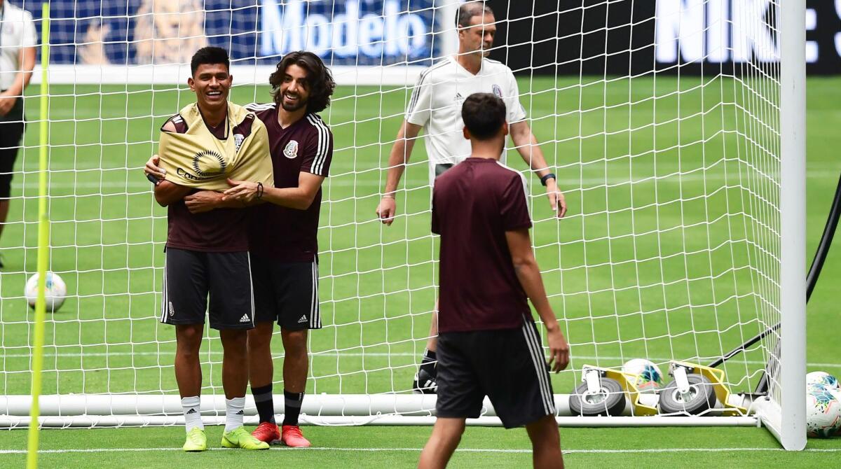 Mexico's Rodolfo Pizarro (L) shares a light moment with teammate Jesus Gallardo during a training session at State Farm Stadium in Glendale, Arizona on July 1, 2019 a day before the 2019 Concacaf Gold Cup semifinal between Mexico and Haiti. (Photo by Frederic J. BROWN / AFP)FREDERIC J. BROWN/AFP/Getty Images ** OUTS - ELSENT, FPG, CM - OUTS * NM, PH, VA if sourced by CT, LA or MoD **