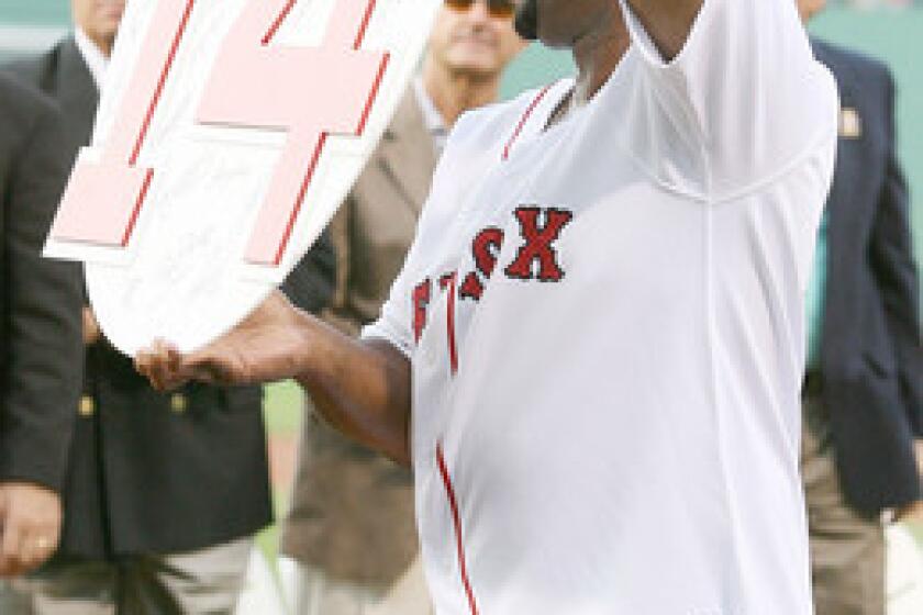 Former Boston Red Sox outfielder Jim Rice shows off his retired number plaque during a ceremony before the Boston Red Sox game against the Oakland Athletics at Fenway Park July 28, 2009 in Boston.