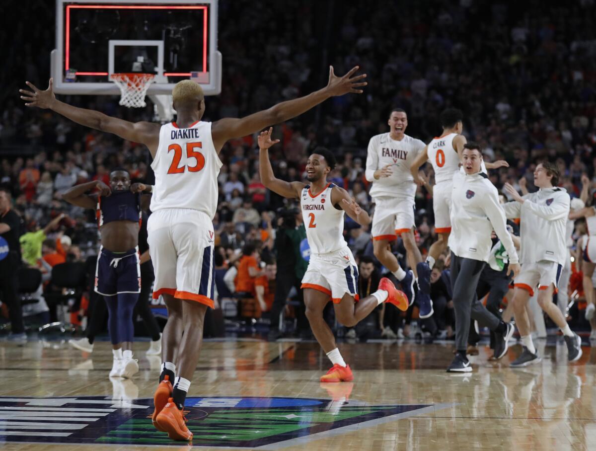 Virginia players celebrate after defeating Auburn 63-62 in the Final Four of the NCAA tournament on Saturday in Minneapolis.