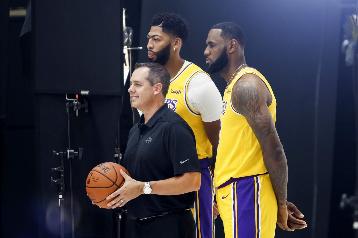 Lakers coach Frank Vogel poses with LeBron James, and Anthony Davis for a photo during media day.