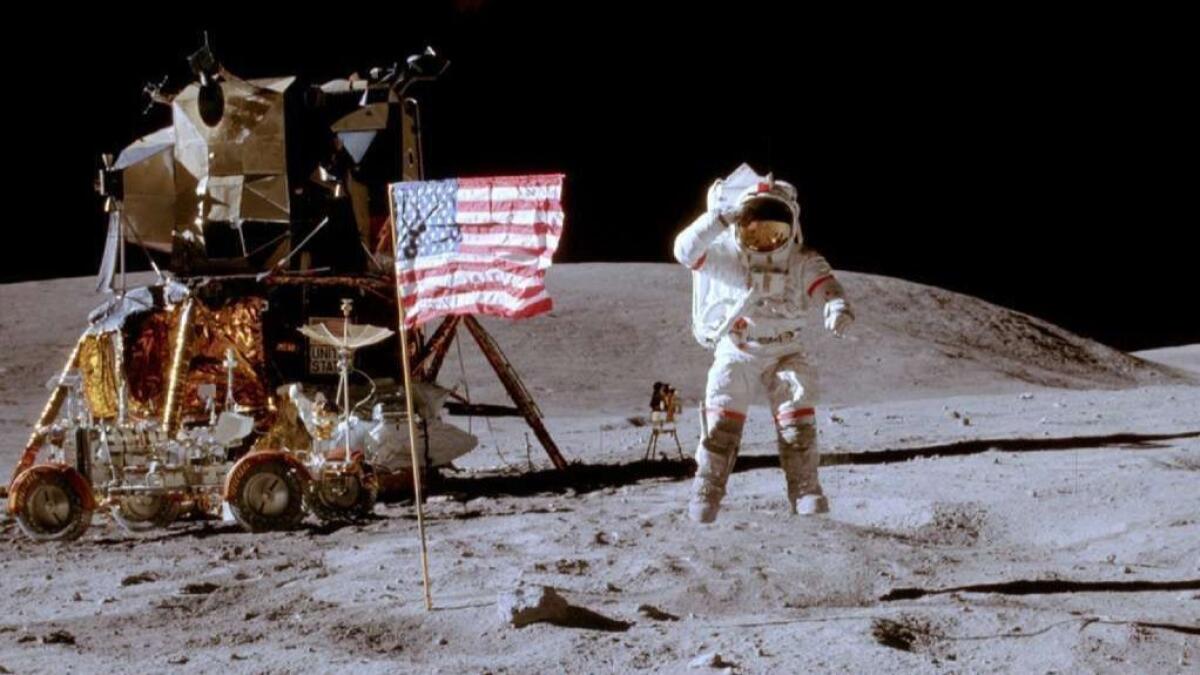 Astronaut John W. Young leaps from the lunar surface as he salutes the American flag during the Apollo 16 mission in April 1972.