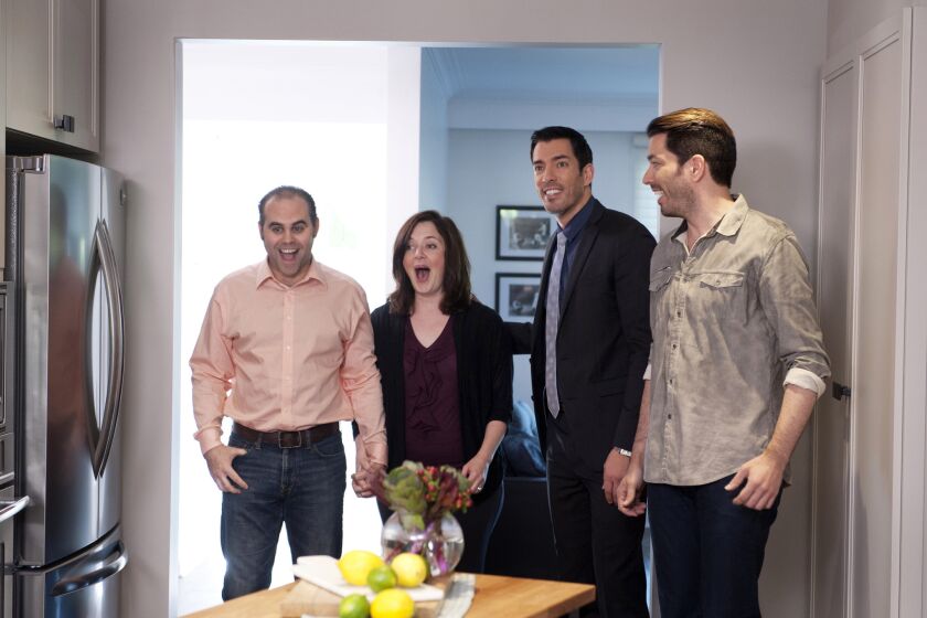 A couple see their new kitchen for the first time as Drew and Jonathan Scott give them a tour on HGTV's "Property Brothers."