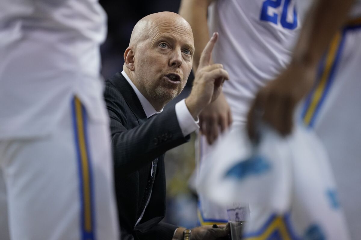 UCLA coach Mick Cronin speaks with players during a timeout against Long Beach State on Nov. 15.