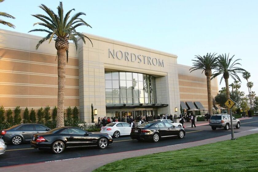 Cars line up for valet parking for a gala at Nordstrom Fashion Island.