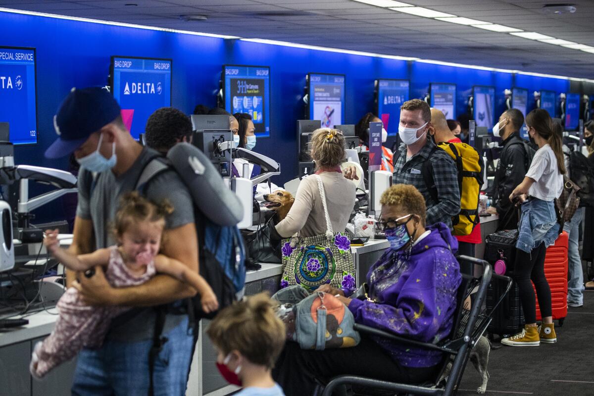 A crowd of Memorial Day weekend travelers check in for flights at LAX at Delta Airlines, Terminal 2 Friday, May 28, 2021.