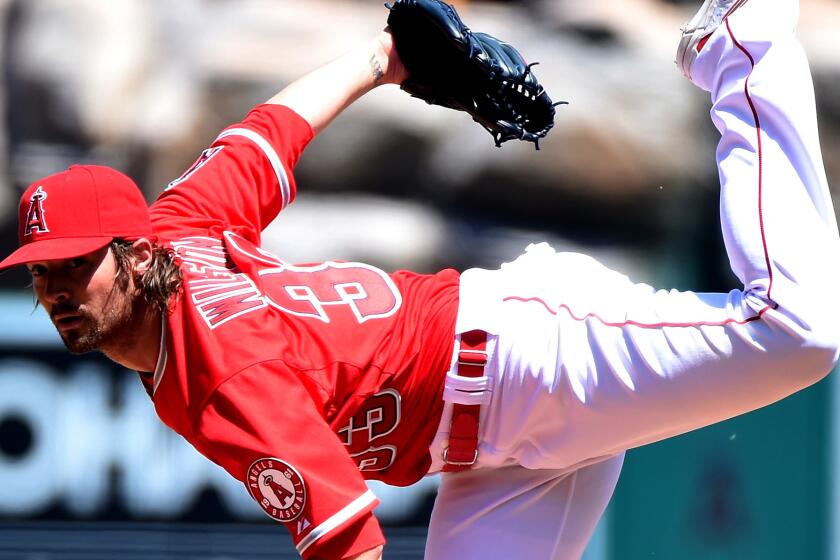 C.J. Wilson delivers a pitch against the Royals on Sunday during the Angels' loss.