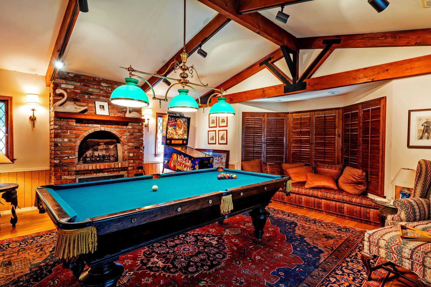 The home has two brick fireplaces and a bar in the den.