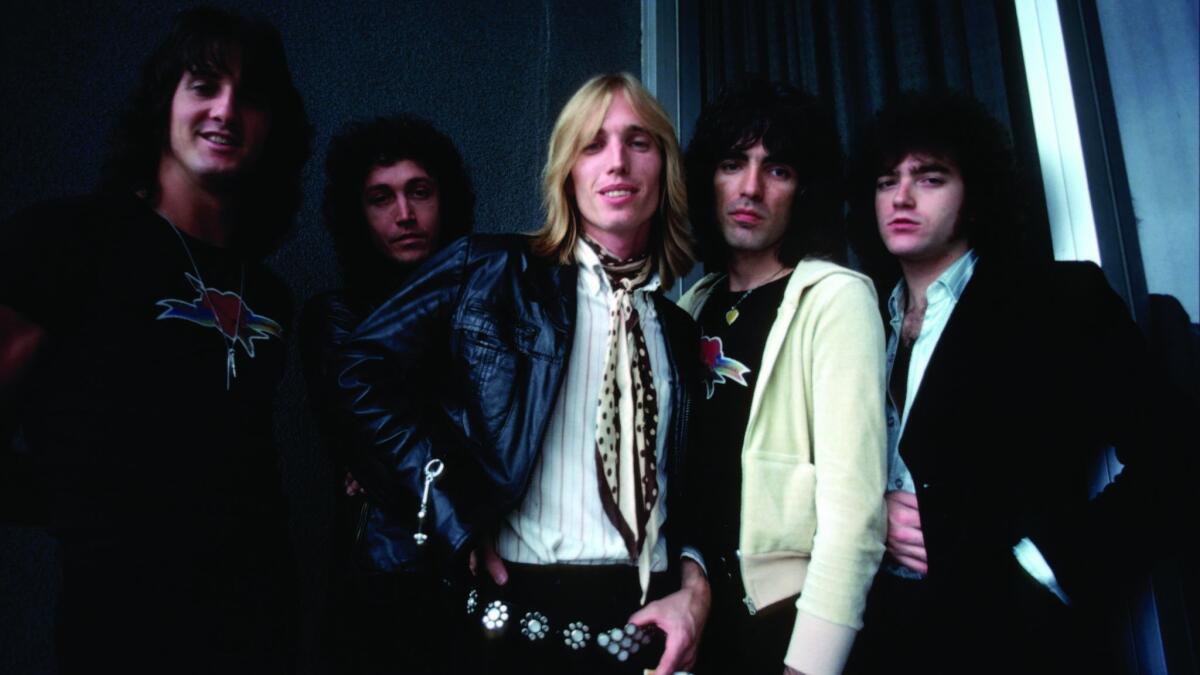 Tom Petty and The Heartbreakers pose for a portrait backstage in August 1977 in Los Angeles,