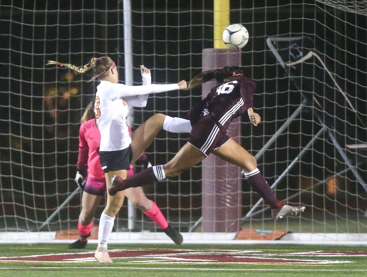 Laguna Beach's Reilyn Turner heads the ball in for the game's first goal against Huntington Beach in a Sunset Conference crossover match in Laguna Beach on Jan. 3.