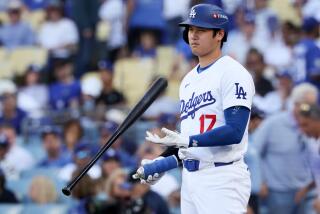 LOS ANGELES, CALIFORNIA - OCTOBER 14: Shohei Ohtani #17 of the Los Angeles Dodgers flips his bat.