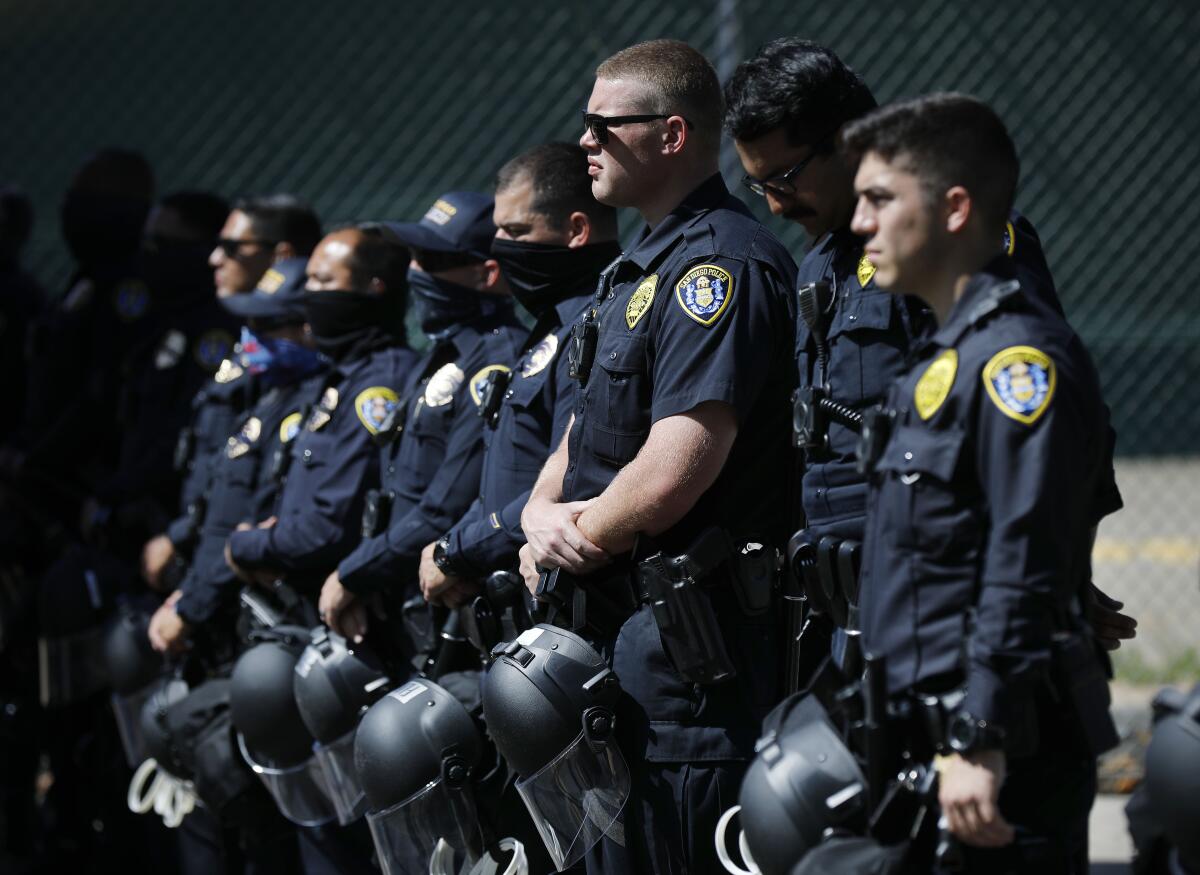 San Diego police officers stand near police headquarters.