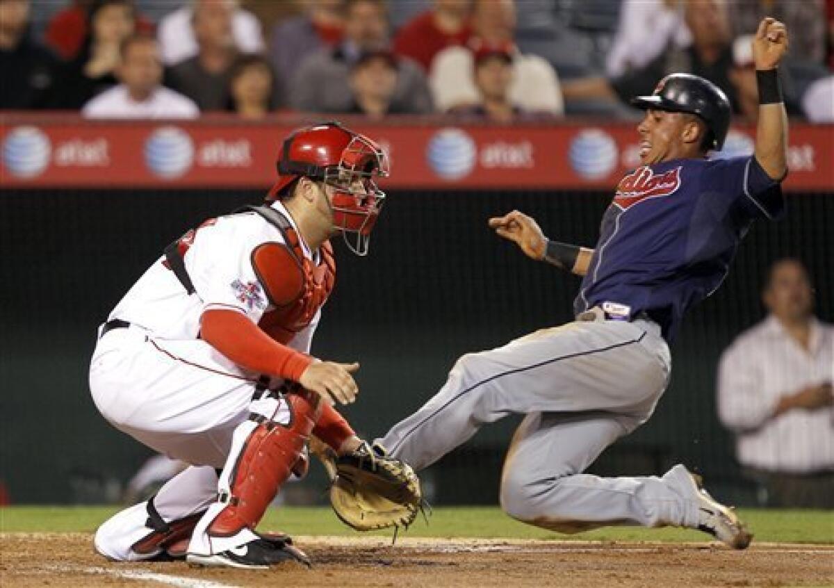 Cleveland Indians' Michael Brantley, right, scores ahead of the throw to Los Angeles Angels catcher Mike Napoli in the third inning on a sacrifice fly to center field by Shin-Soo Choo in a baseball game Tuesday, Sept. 7, 2010, in Anaheim, Calif. (AP Photo/Alex Gallardo)