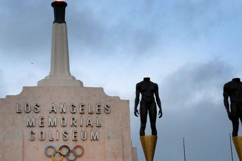 In this Wednesday, Sept. 13, 2017 photo a blazing Olympic cauldron is seen at the Los Angeles Memorial Coliseum. The cauldron was lit early Wednesday morning at the stadium that was the site of the 1932 and 1984 Olympics. An International Olympic Committee meeting in Peru made it official that LA will host in 2028 and that the 2024 Games will go to Paris. (AP Photo/Richard Vogel)