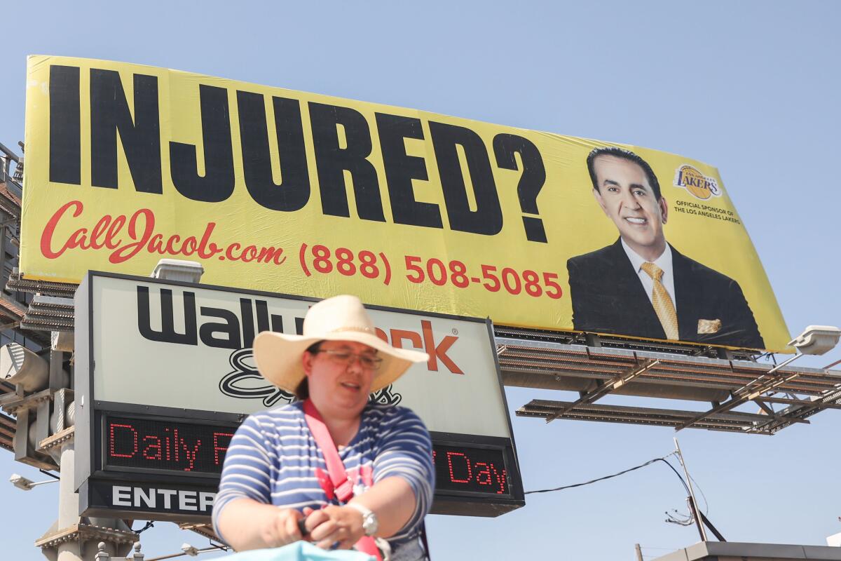 A billboard saying Injured? Call Jacob.com. It advertises a real business.