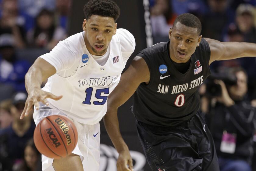 Duke's Jahlil Okafor (15) and San Diego State's Skylar Spencer (0) chase a loose ball during the second half of an NCAA tournament game on March 22.