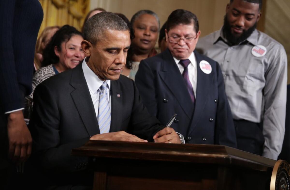 President Obama is seen last month in the White house signing an executive order to raise the minimum wage for federal contractors from $7.25 to $10.10 per hour. Critics have warned that the president's promise to act in the face of congressional gridlock might amount to executive overreach.