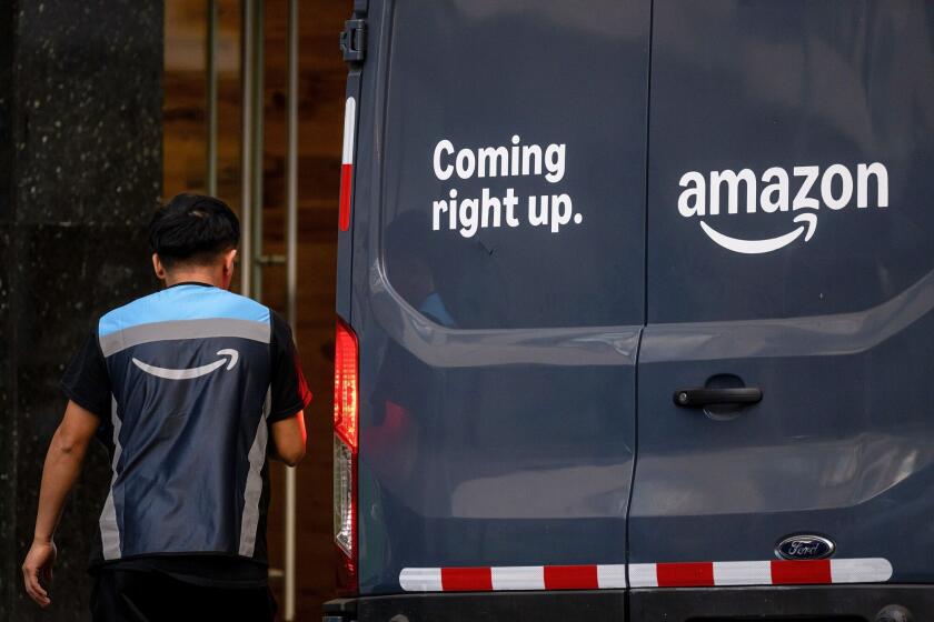 A worker near an Amazon delivery vehicle in San Francisco, California. Photographer: David Paul Morris/Bloomberg