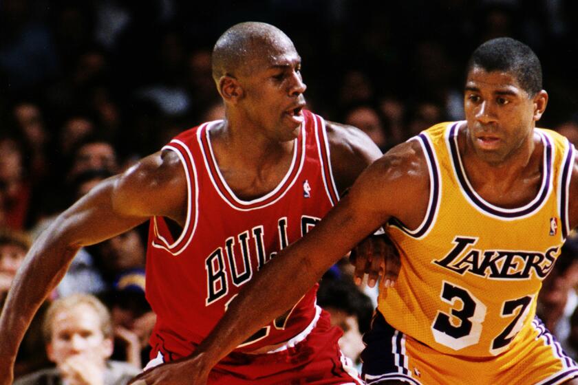 LOS ANGELES, CA Spring, 1991 –– Los Angeles Lakers Magic Johnson, right, is guarded by Michael Jordan of the Chicago Bulls in the 1991 NBA Finals in Los Angeles. (Al Seib / Los Angeles Times)