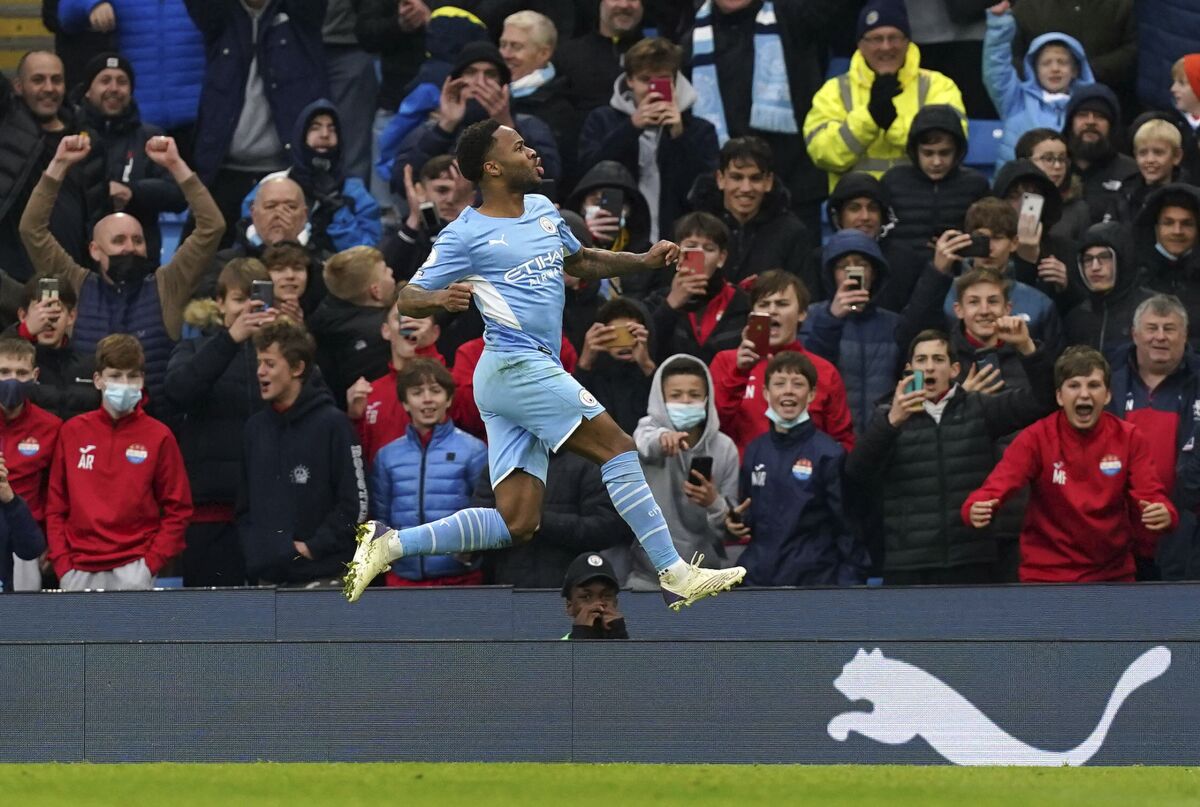 Manchester City's Raheem Sterling celebrates after scoring his side's first goal on a penalty kick during the English Premier League soccer match between Manchester City and Wolverhampton Wanderers, at the Etihad stadium in Manchester, England, Saturday, Dec.11, 2021(Martin Rickett/PA via AP)