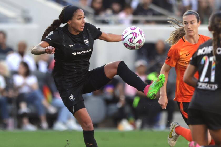 LOS ANGELES, CALIFORNIA - JUNE 25: Sydney Leroux #2 of Angel City FC controls the ball as Katie Lind.