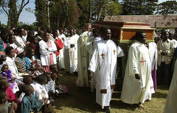 Catholic priests carry the coffin of Father Kaiser