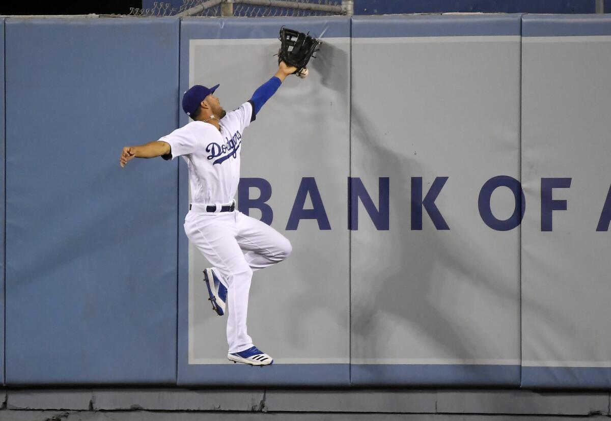 Dodgers center fielder Kristopher Negron can't make a catch.