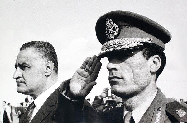 In this undated 1969 photo, Col. Moammar Kadafi salutes as he appears with Egypt's Prime Minister Gamal Abdel Nasser in Suez, Egypt.