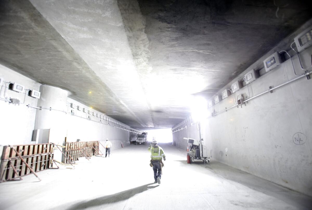 Contractor Hercor Ponce walks through the refurbished tunnel connecting the northbound 2 Freeway to the northbound 5 Freeway as repairs wind up last week. The connector was scheduled to reopen by noon on Friday.