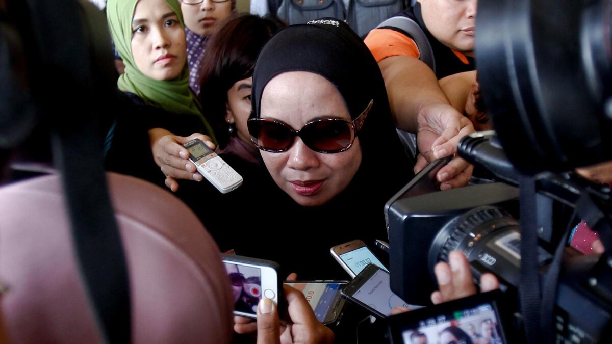 The mother of fire victim Hartini Abdul Ghani speaks to journalists during the court hearing Thursday in Kuala Lumpur, Malaysia.