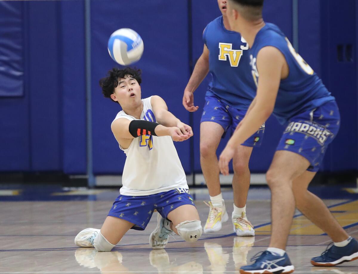 Fountain Valley's Arion Wang runs down a dig to keep a point going against Capistrano Valley Christian on Monday.