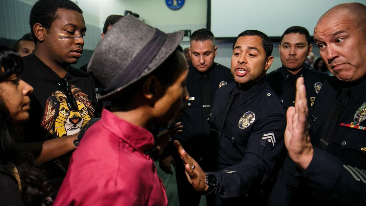 Protesters interrupt a Los Angeles Police Commission meeting.