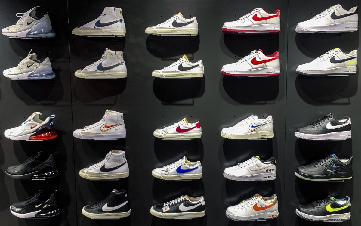 Five rows of Nike sneakers stand on a vertical display