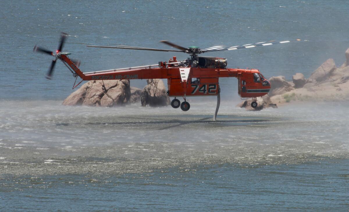 An Erickson Air-Crane loads up from Lake Isabella on Sunday before making another water drop on the Shirley fire.