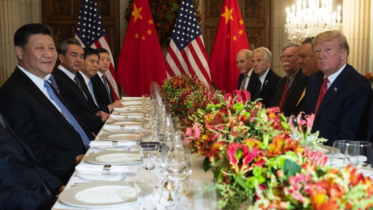 President Trump, Chinese President Xi Jinping and others around a table at the G-20 conference last year.
