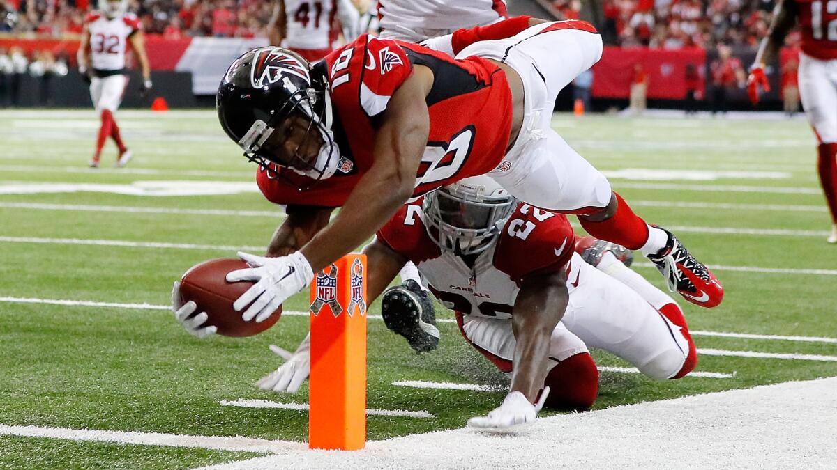 Falcons receiver Taylor Gabriel dives for the pylon past Cardinals defensive back Tony Jefferson to score a touchdown during the second half Sunday.